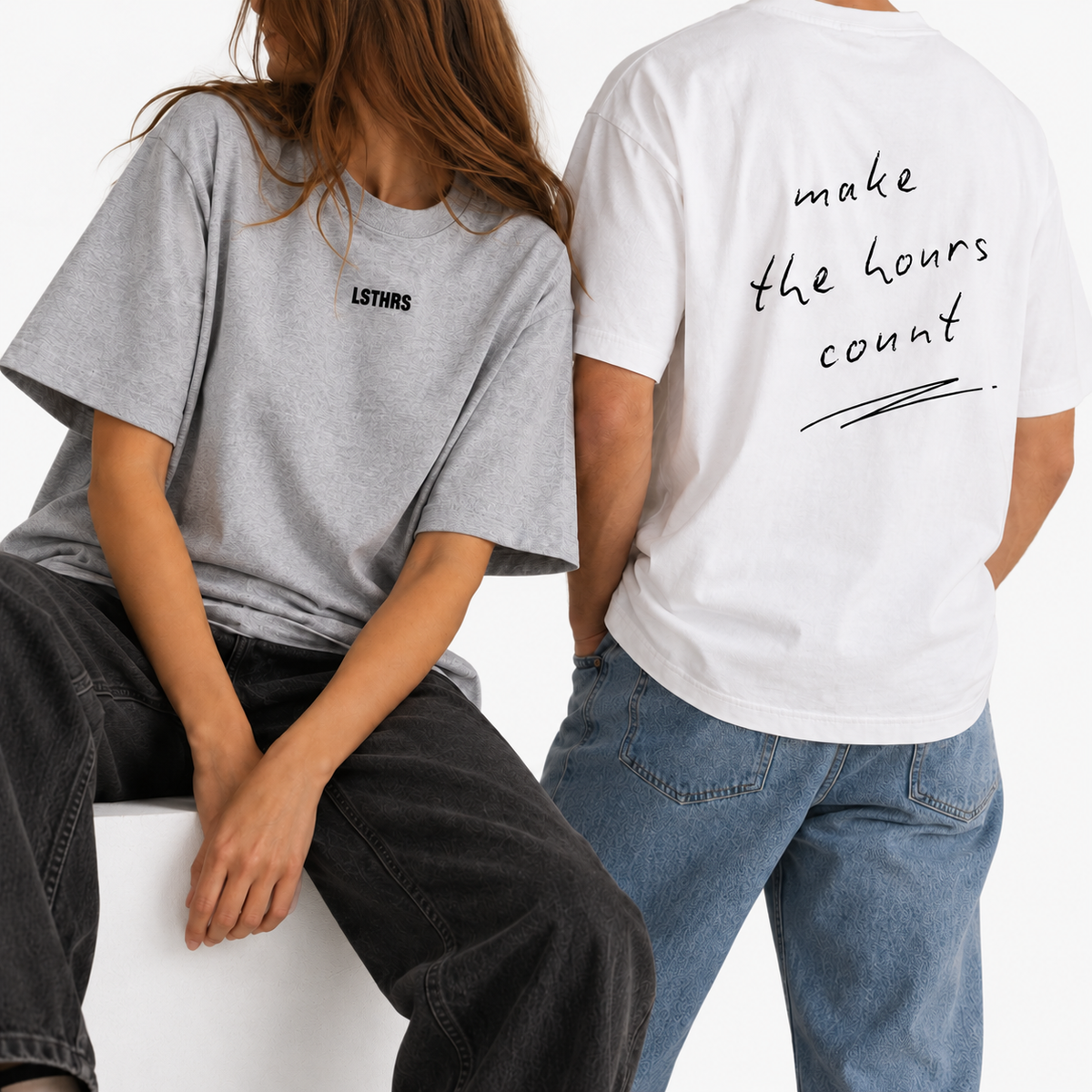 Two models wearing white and grey LSTHRS Make the Hours Count oversized T-shirts